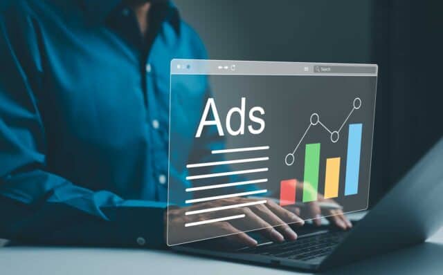 Ad On Website And Social Media, Banner Ads On Internet, Digital Marketing Concept. Marketer Analyzing Online Advertising Campaigns And Performance Metrics On A Laptop With A Graphical Data Interface.