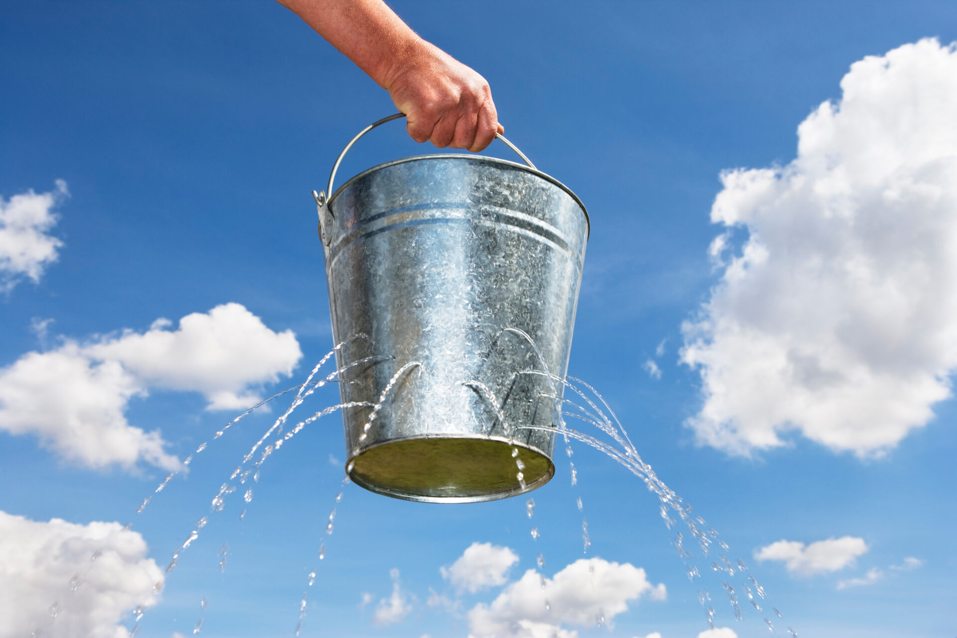 Man Holding Bucket With Holes Leaking Water